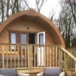 Timber glamping pod with veranda and rattan seating, Yorkshire Wolds