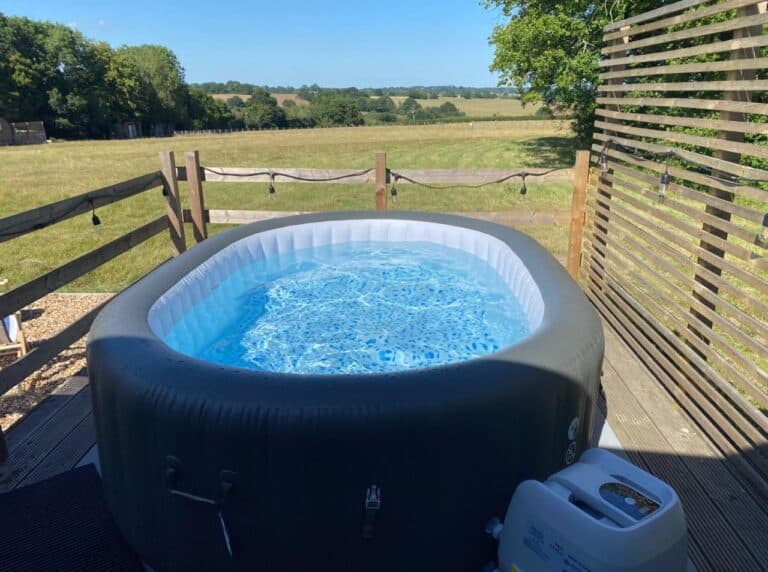 An inflatable hot tub on the deck overlooking the fields