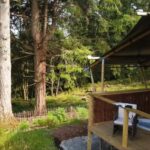 Safari tent with hot tub among pine trees at Skelwith Fold, Ambleside, Lake District