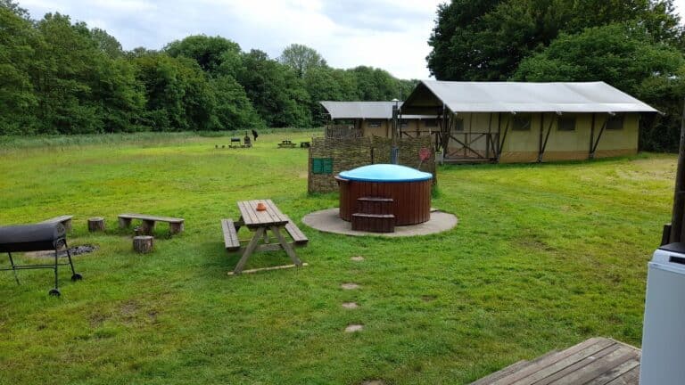 Hot tub by a safari tent at Hidden Meadows Glamping Suffolk