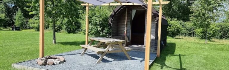 Glamping pod with picnic bench at Meadow Falls Lancashire