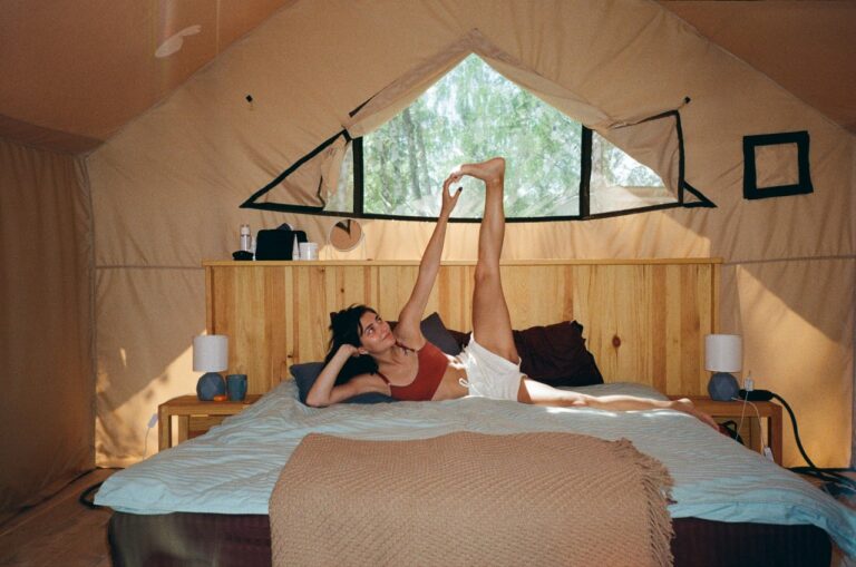 woman doing yoga in a glamping tent credits Ksenia Kazak unsplash
