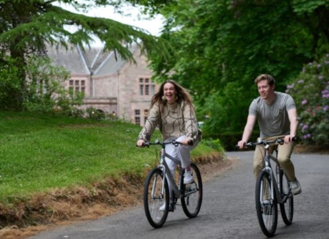 Couple riding bikes at the Murrayshall Estate Perthshire Scotalnd