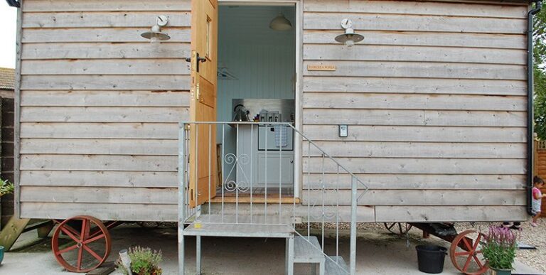 Shepherds Hut with door open at To Rest A While Glamping Somerset