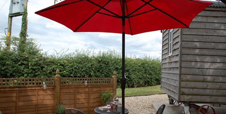 Red outdoor umbrella at To Rest A While Glamping Somerset