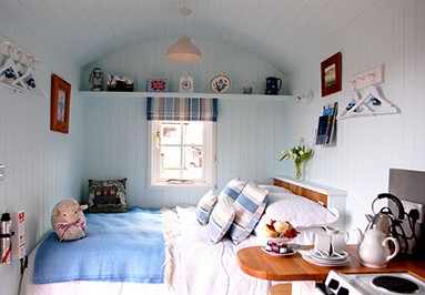 Bed in shepherds hut at To Rest A While Glamping Somerset