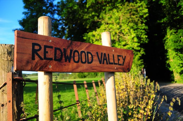 The Redwood Valley sign at the entrance to the glamping site near Presteigne, Powys