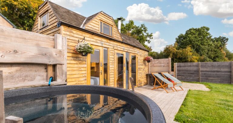 Wood-fired hot tub and decked terrace outside Tinywood One, a tiny house in the Warwickshire countryside