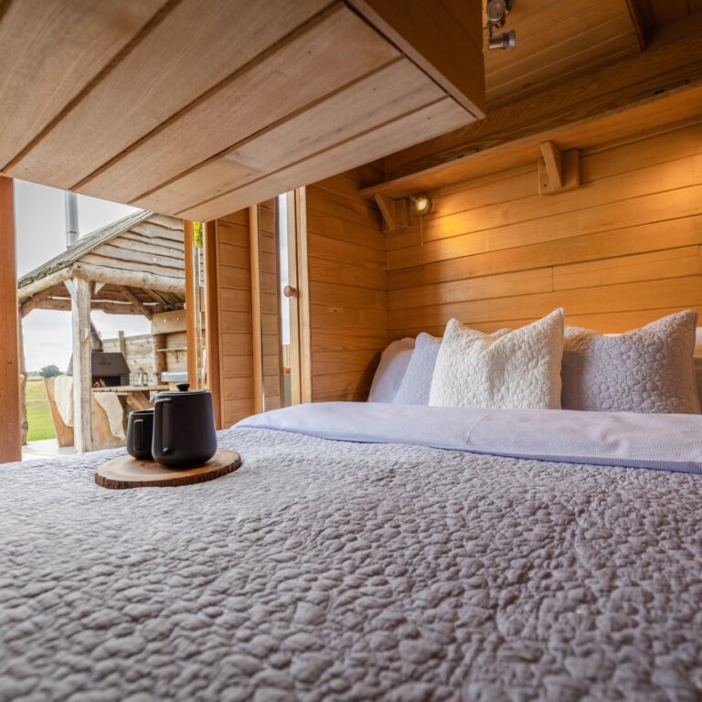 King size bed at Tinywood One with a view out across the Warwickshire fields