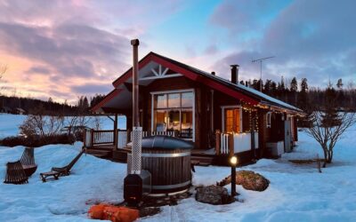 cabin in the snow with hot tub and fairy lights